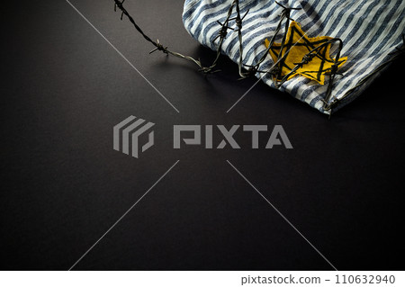 Jewish prisoner with yellow badge on dark background. International Holocaust Remembrance Day 110632940