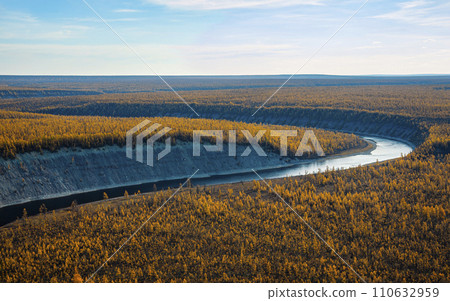 Autumn bright larch taiga in the floodplain of the northern Siberian river. Autumn bright larch taiga in the floodplain of the northern Siberian river. 110632959