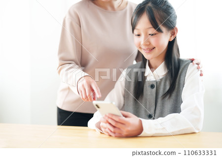 Girls using smartphones 110633331
