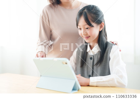 Girls using tablets Girls using tablets 110633336