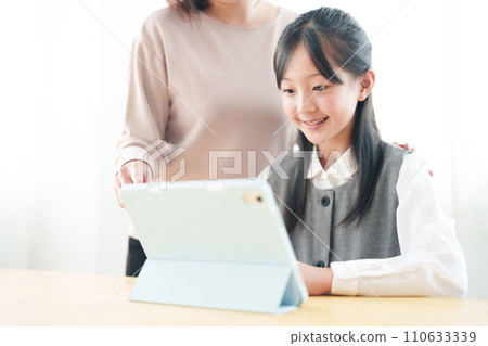 Girls using tablets Girls using tablets 110633339