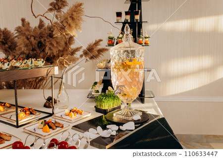 Assortment of delicious snacks on the open buffet festive table in restaurant. Catering plate 110633447