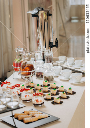 Dessert buffet with delicious sweet bakery and coffee-snack with stylish banks of lemonade and tea Dessert buffet with delicious sweet bakery and coffee-snack with stylish banks of lemonade and tea 110633465