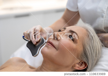 Mature gray-haired woman having a mesotherapy treatment 110633989