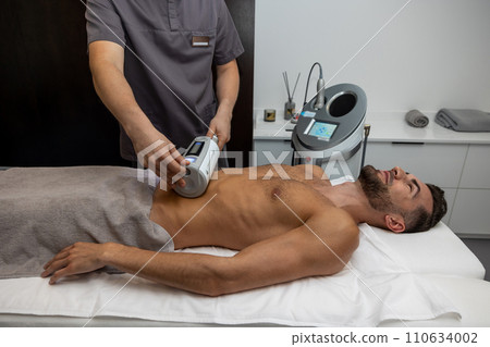 Young dark-haired man having medical procedures in a clinic Young dark-haired man having medical procedures in a clinic 110634002