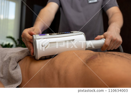 Young dark-haired man having medical procedures in a clinic 110634003