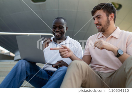 Two colleagues working together remotely and looking involved Two colleagues working together remotely and looking involved 110634110