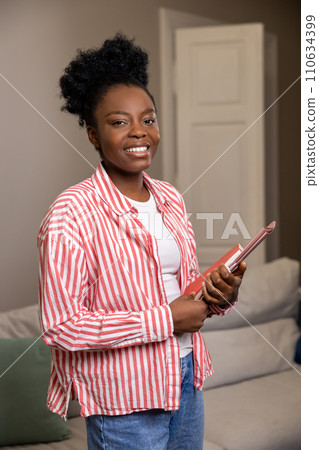 Black woman realtor holding folder with documents of new house. Black woman realtor holding folder with documents of new house. 110634399
