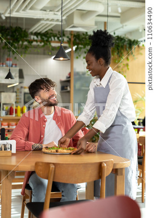 African american waitress taking order from customer in a cafe 110634490