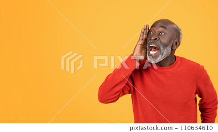 Joyful elderly man in a red sweater loudly sharing exciting news or gossip, hand to mouth 110634610