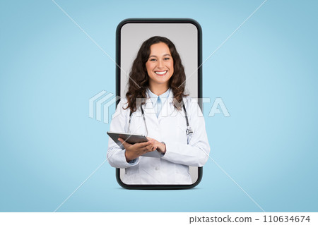Appointment with doc online. Cheerful female doctor with digital pad and stethoscope at huge smartphone screen 110634674