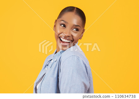 Portrait of playful pretty black woman smiling looking aside, studio Portrait of playful pretty black woman smiling looking aside, studio 110634738