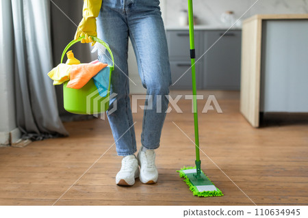 Woman with bucket and mop ready for floor cleaning Woman with bucket and mop ready for floor cleaning 110634945