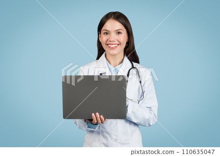 Smiling doctor holding laptop, telehealth concept 110635047