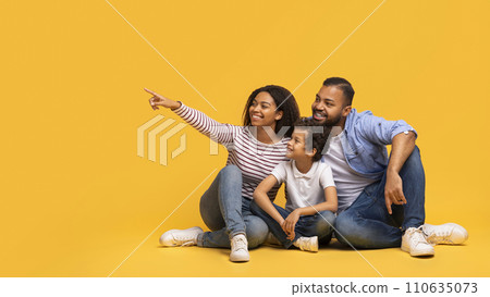 Family Offer. Happy Black Parents And Little Son Pointing At Copy Space Family Offer. Happy Black Parents And Little Son Pointing At Copy Space 110635073
