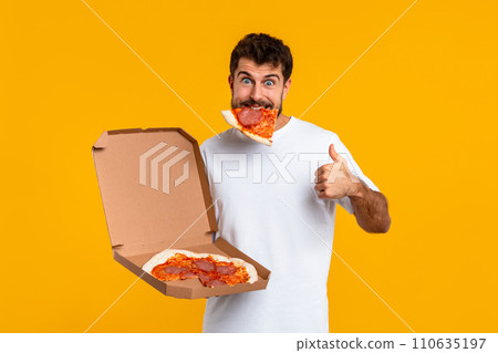 Happy Guy With Slice Of Pizza Gesturing Thumbs Up, Studio 110635197