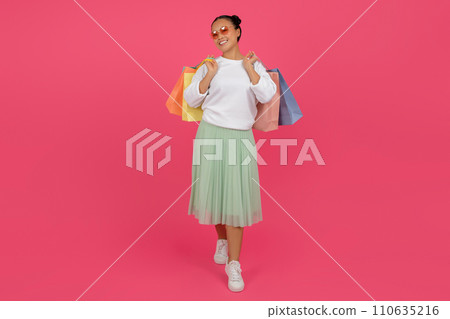 Happy Asian Woman Walking With Shopping Bags In Hands On Pink Background 110635216