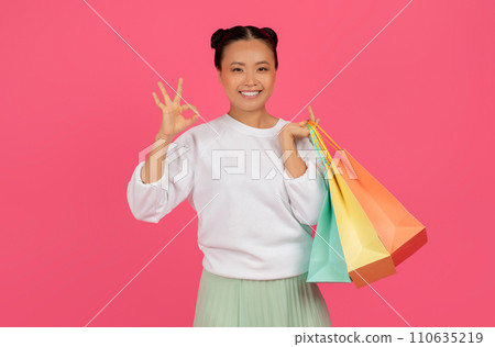 Big Sales. Happy Asian Female Holding Shopping Bags And Showing Ok Gesture 110635219
