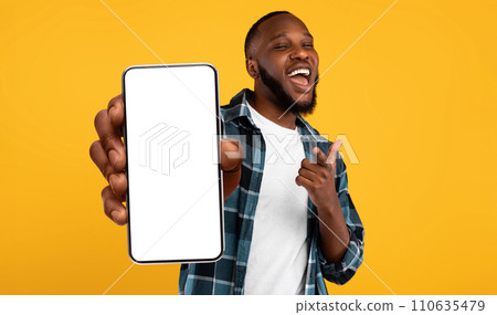 Black guy showing white empty smartphone screen, closeup 110635479