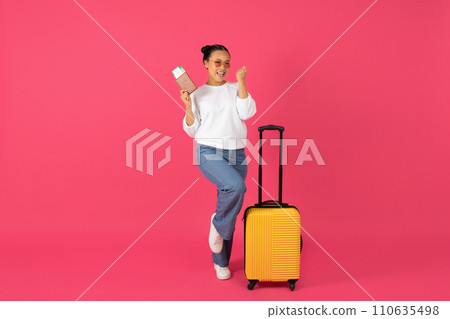 Joyful young asian traveler woman holding passport with tickets and celebrating success 110635498