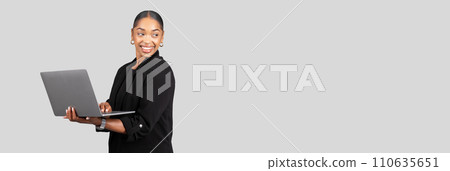 A cheerful businesswoman holds a laptop with one hand while smiling and looking to the side A cheerful businesswoman holds a laptop with one hand while smiling and looking to the side 110635651