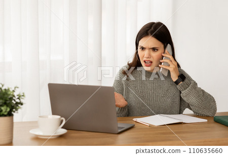 Angry young businesswoman have phone conversation with assistant 110635660