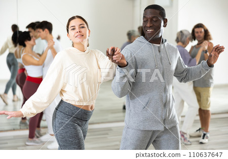 Dancing positive couples learning salsa Dancing positive couples learning salsa 110637647