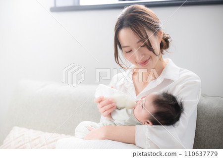A woman feeding her baby 110637779