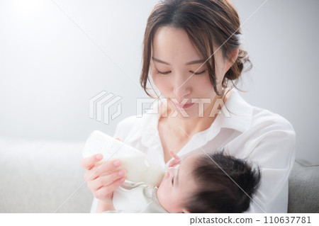 Close-up of a woman feeding milk to a baby, so cute and precious 110637781