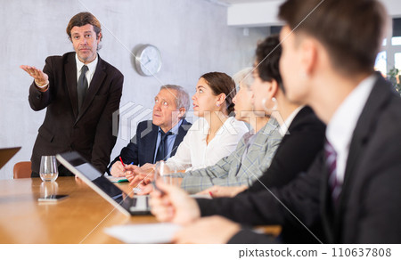 Successful businessman tells his colleagues the presentation and future plans of company Successful businessman tells his colleagues the presentation and future plans of company 110637808
