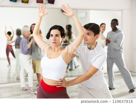 Caucasian man and lady rehearsing latin paired dance moves Caucasian man and lady rehearsing latin paired dance moves 110637818