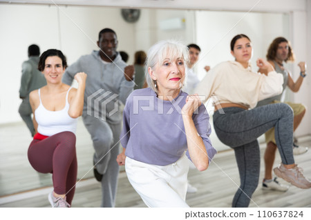 Elderly lady learning modern dynamic dances in choreography class 110637824