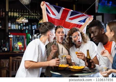 Group of United Kingdom football team fans spending time in bar 110637856