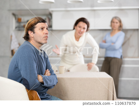 Elderly mother and woman during family quarrel accuse adult man Elderly mother and woman during family quarrel accuse adult man 110637870