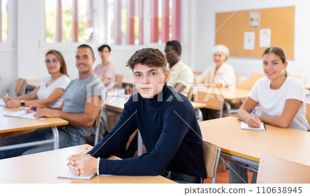 Focused guy attending foreign languages courses for adults Focused guy attending foreign languages courses for adults 110638945