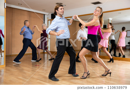 Middle-aged pair practicing Latino dance in dance studio 110638979