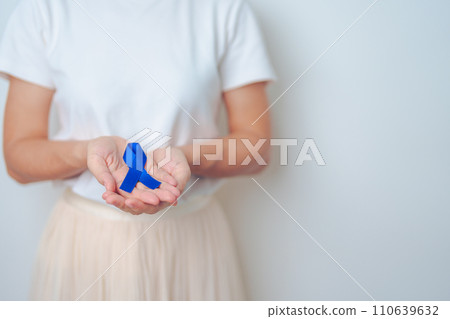 March Colorectal Cancer Awareness month, doctor with dark Blue Ribbon for supporting people living and illness. Healthcare, hope and World cancer day concept 110639632