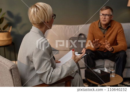 Back view of female psychologist listening to man during therapy session one on one, copy space Back view of female psychologist listening to man during therapy session one on one, copy space 110640232