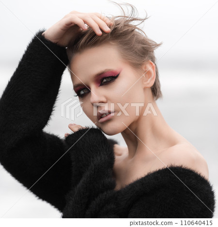 Portrait of blonde woman with short hair, bright makeup looking at camera, white natural background Portrait of blonde woman with short hair, bright makeup looking at camera, white natural background 110640415