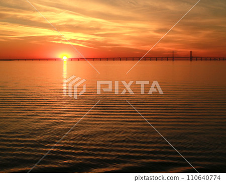 View of the bridge floating on the Baltic Sea at dawn from the boat View of the bridge floating on the Baltic Sea at dawn from the boat 110640774