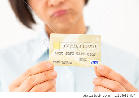 Middle-aged woman worried about credit card Middle-aged woman worried about credit card 110641494