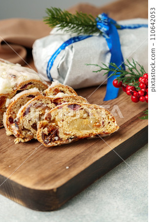 Christmas stollen on wooden cutting board close up 110642053