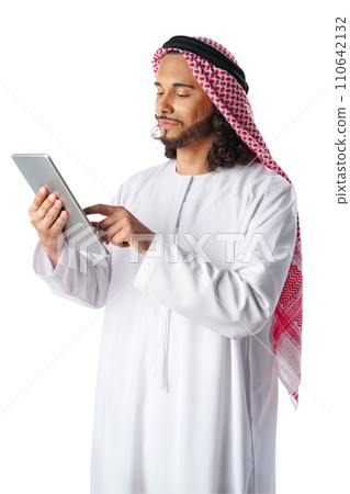 Arab man using digital tablet wearing traditional clothes isolated on white Arab man using digital tablet wearing traditional clothes isolated on white 110642132
