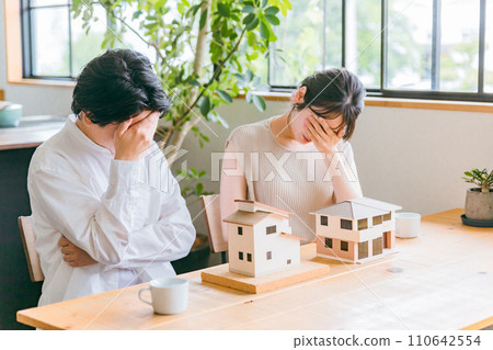 Couple worried about purchasing a home (two-family home, own home, mortgage) Couple worried about purchasing a home (two-family home, own home, mortgage) 110642554