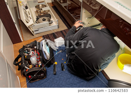 Work scene of repairing a plumbing problem in a kitchen faucet Work scene of repairing a plumbing problem in a kitchen faucet 110642583