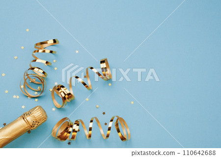 Champagne bottle with confetti stars on color background, space for text 110642688