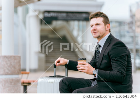 Foreign businessmen at a bus stop, taxi stand, or waiting area on a business trip or trip Foreign businessmen at a bus stop, taxi stand, or waiting area on a business trip or trip 110643304