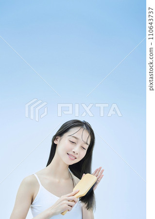 long-haired woman brushing her hair long-haired woman brushing her hair 110643737