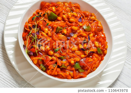 chakalaka, spicy tomato bean relish in white bowl 110643978