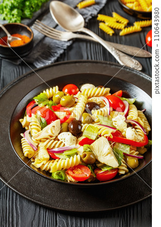 fusilli salad with mozzarella, veggies in a bowl fusilli salad with mozzarella, veggies in a bowl 110643980